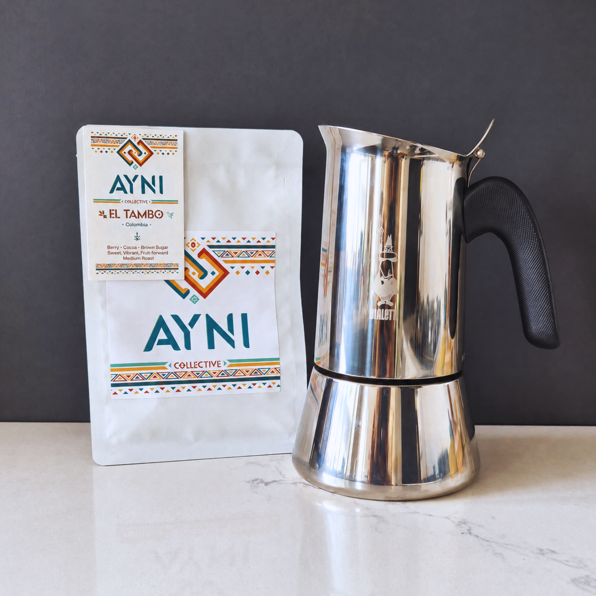 A moka pot next to Ayni El Tambo bag