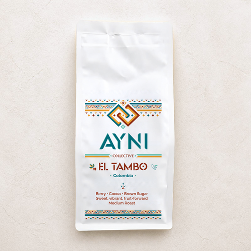 A white bag of Ayni Collective El Tambo Colombia coffee, featuring colorful geometric patterns and product details, set against a textured light beige background.